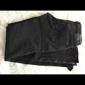 Black skinny jeans with zippers at ankles